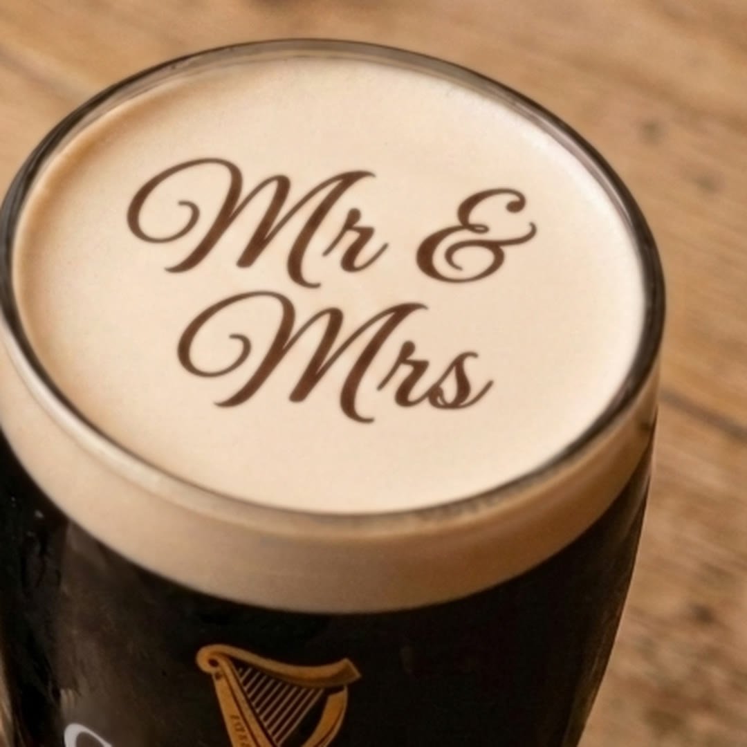 Mr and Mrs in script lettering printed on the head of a Guinness pint